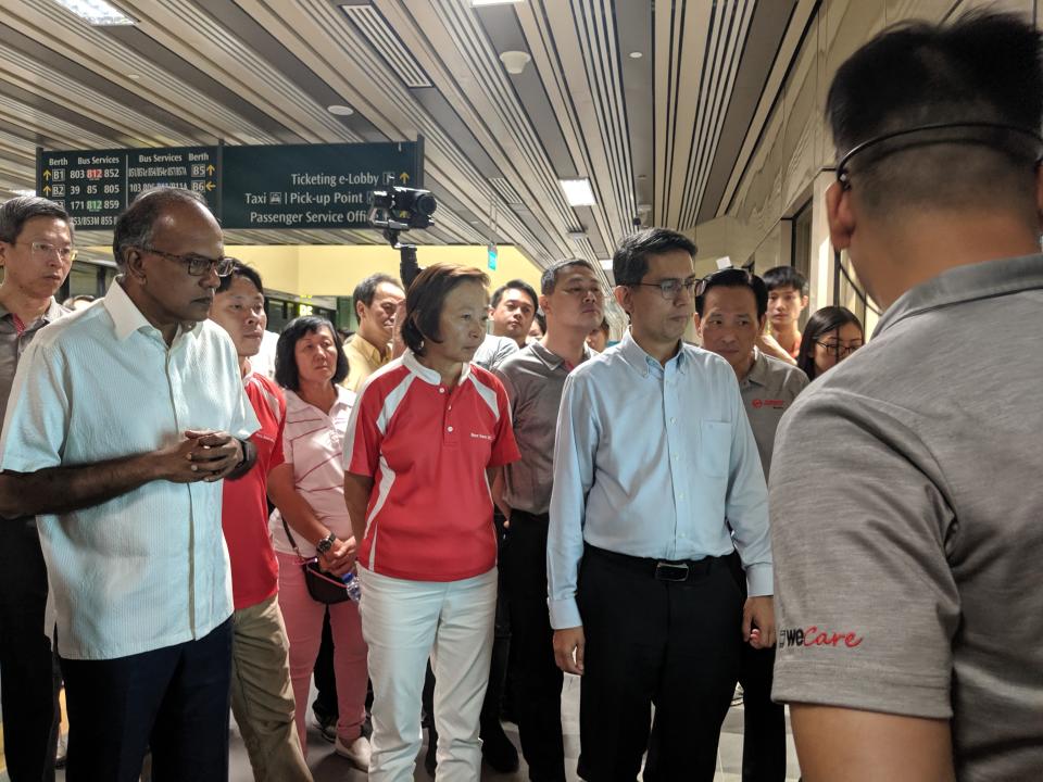 Left to right: Nee Soon GRC MPs - Law and Home Affairs Minister K Shanmugam, Lee Bee Wah and Senior Parliamentary Secretary for Social and Family Development Muhammad Faishal Ibrahim - listening to an SMRT staff member explain about the hub's features on 23 August, 2019. (PHOTO: Yahoo News Singapore)