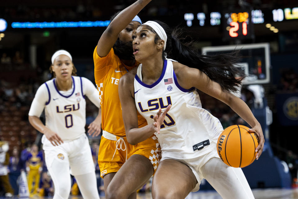 LSU's Angel Reese, right, drives to the basket against Tennessee's Rickea Jackson in the first half of an NCAA college basketball game during the Southeastern Conference women's tournament in Greenville, S.C., Saturday, March 4, 2023. (AP Photo/Mic Smith)