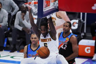 Denver Nuggets forward Will Barton (5) dunks in front of Oklahoma City Thunder forward Darius Bazley, left, and center Al Horford (42) during the second half of an NBA basketball game Saturday, Feb. 27, 2021, in Oklahoma City. (AP Photo/Sue Ogrocki)