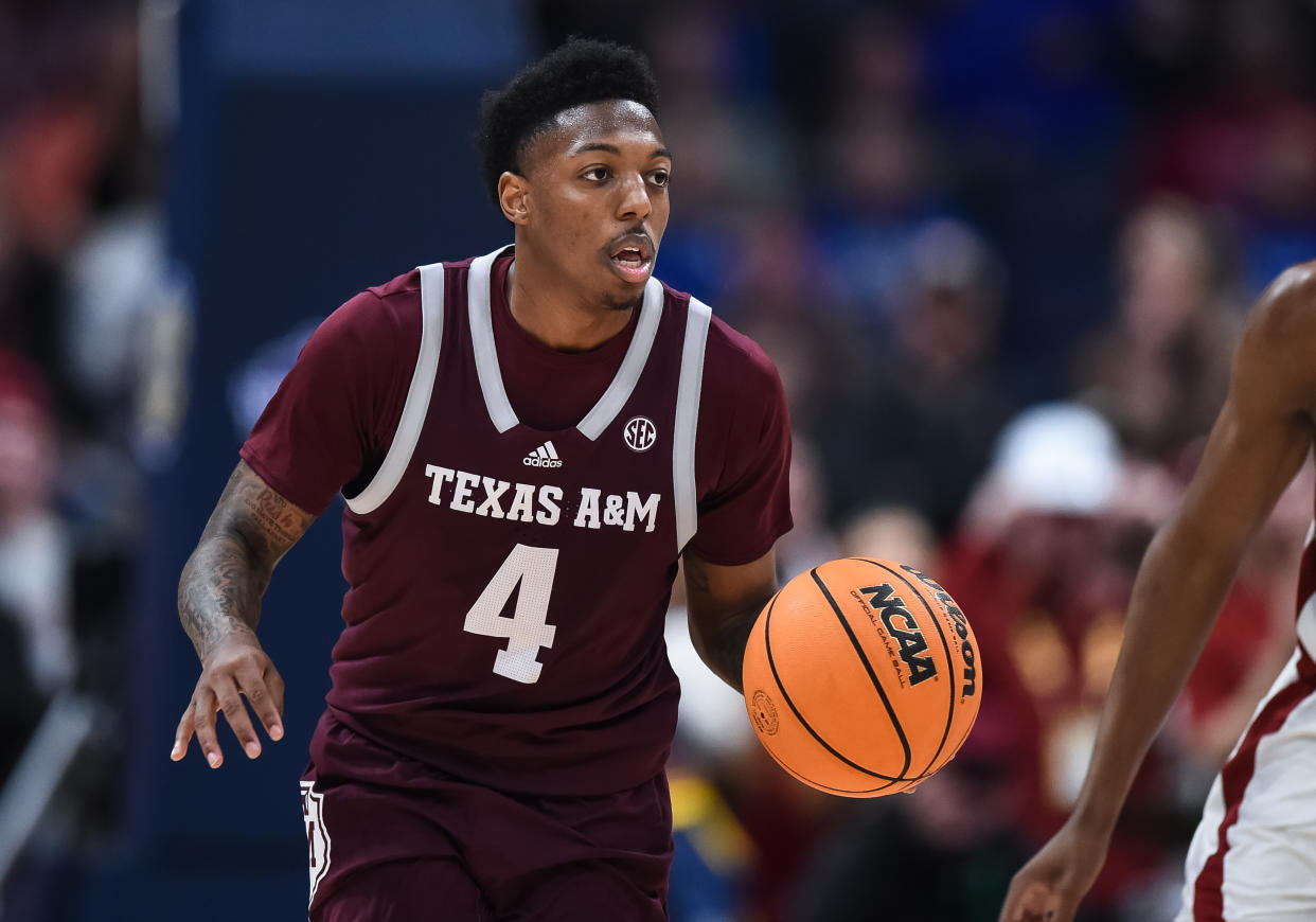 NASHVILLE, TN - MARCH 12: Texas A&M Aggies guard Wade Taylor IV (4) pushes the ball up the court during the SEC Mens Basketball Tournament championship game between the Alabama Crimson Tide and the Texas A&M Aggies on March 12, 2023 at Bridgestone Arena in Nashville, TN. (Photo by Bryan Lynn/Icon Sportswire via Getty Images)