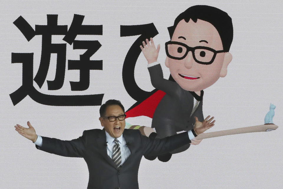 Toyota Motor Corp. President Akio Toyoda speaks during Toyota's presentation of the media preview of the Tokyo Motor Show in Tokyo Wednesday, Oct. 23, 2019. The Japanese letters in the background read: "Play." (AP Photo/Koji Sasahara)