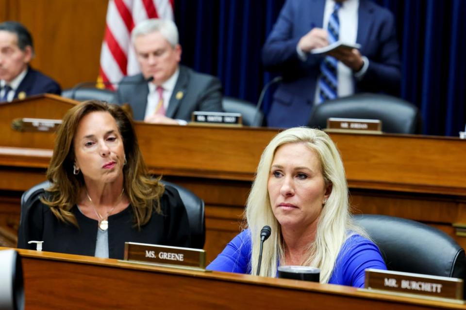 Rep. Lisa McClain (R-MI) and Rep. Marjorie Taylor Greene (R-GA) listen to testimony during a House Oversight and Accountability Committee hearing