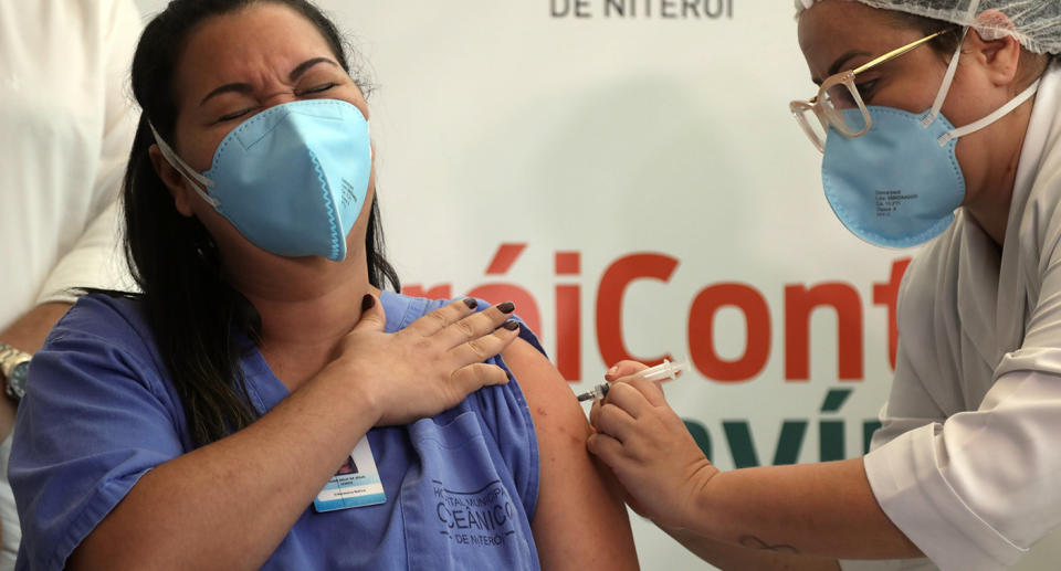 A health worker gets a Covid vaccine. Source: AP