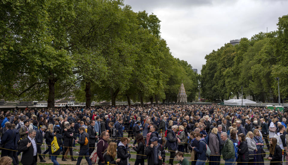 People queue to pay their respect to the late Queen Elizabeth II during the Lying-in State, outside Westminster Hall in London, Thursday, Sept. 15, 2022. The Queen will lie in state in Westminster Hall for four full days before her funeral on Monday Sept. 19. (AP Photo/Emilio Morenatti)