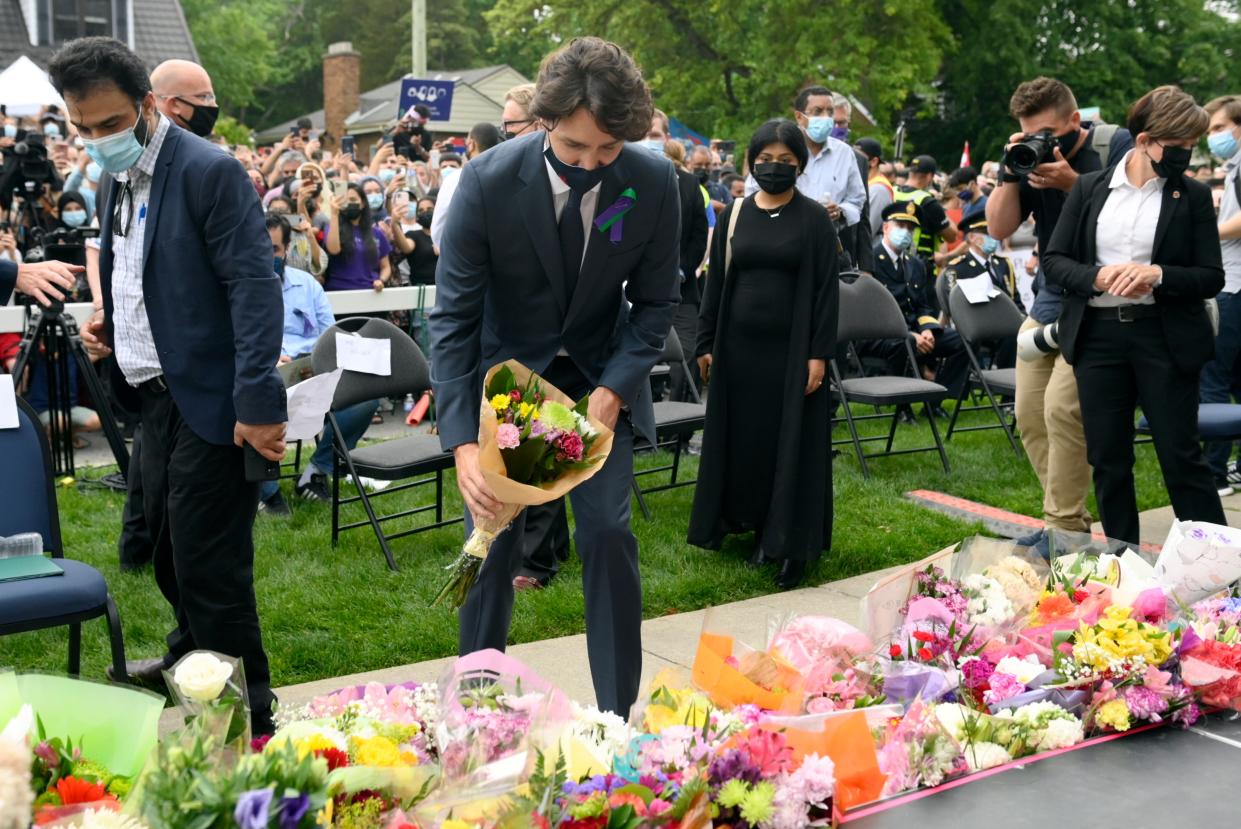 Canada’s Prime Minister Justin Trudeau places flowers at a vigil for the victims of the deadly vehicle attack on five members of the Canadian Muslim community in London, Ontario, on Tuesday, June 8, 2021. (Nathan Denette/The Canadian Press via AP)