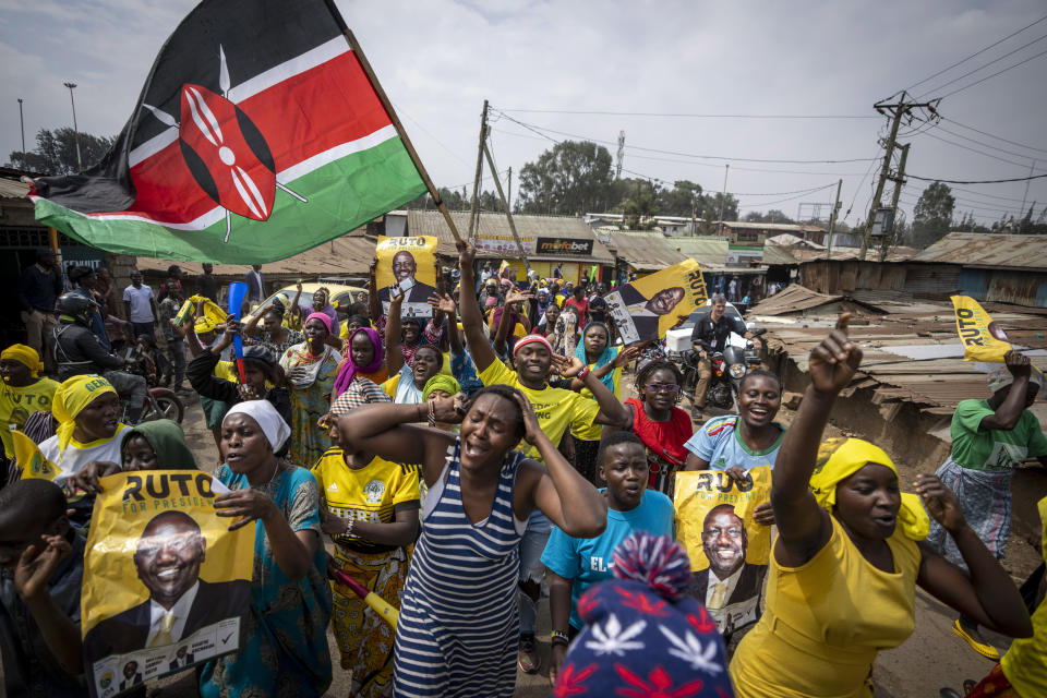 Supporters of William Ruto hold campaign posters of him and wave a national flag as they celebrate and march along a street in the Kibera neighborhood of Nairobi, Kenya Monday, Sept. 5, 2022. Elections, coups, disease outbreaks and extreme weather are some of the main events that occurred across Africa in 2022. Experts say the climate crisis is hitting Africa “first and hardest.” Kevin Mugenya, a senior food security advisor for Mercy Corps said the continent of 54 countries and 1.3 billion people is facing “a catastrophic global food crisis” that “will worsen if actors do not act quickly.” (AP Photo/Ben Curtis)