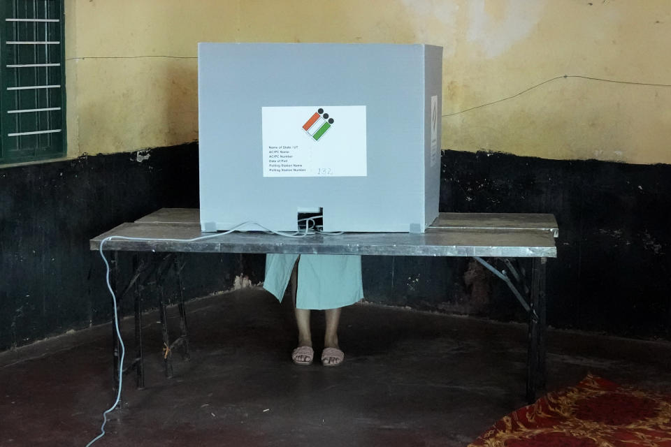 A woman casts her vote at a polling station in Bengaluru, India, Wednesday, May 10, 2023. People in the southern Indian state of Karnataka were voting Wednesday in an election where pre-poll surveys showed the opposition Congress party favored over Prime Minister Narendra Modi's governing Hindu nationalist party. (AP Photo/Aijaz Rahi)