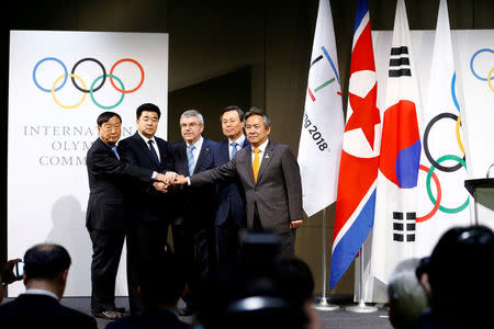 International Olympic Committee (IOC) President Thomas Bach poses with the National Olympic Committee (NOC) of the Republic of Korea (ROK) and the NOC of the Democratic People’s Republic of Korea (DPRK), at the Olympic Museum in Lausanne, Switzerland, January 20, 2018. REUTERS/Pierre Albouy