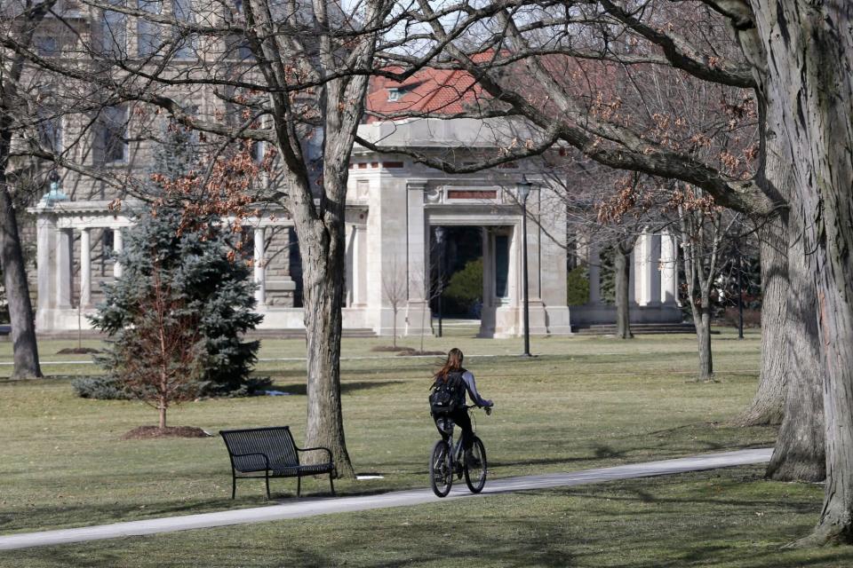 Mandatory Credit: Photo by Tony Dejak/AP/Shutterstock (6218921a) Shows a student riding a bicycle on the campus of Oberlin College in Oberlin, Ohio. A police report says a student at a historically liberal Ohio college took credit for some racist fliers earlier this year, calling them a joke meant to get an overreaction. The student says in statements he gave after Oberlin College security detained him Feb. 27 that he printed out about 1,000 anti-Islam fliers and had also printed out a page of racist cards College Hate Incidents, Oberlin, USA