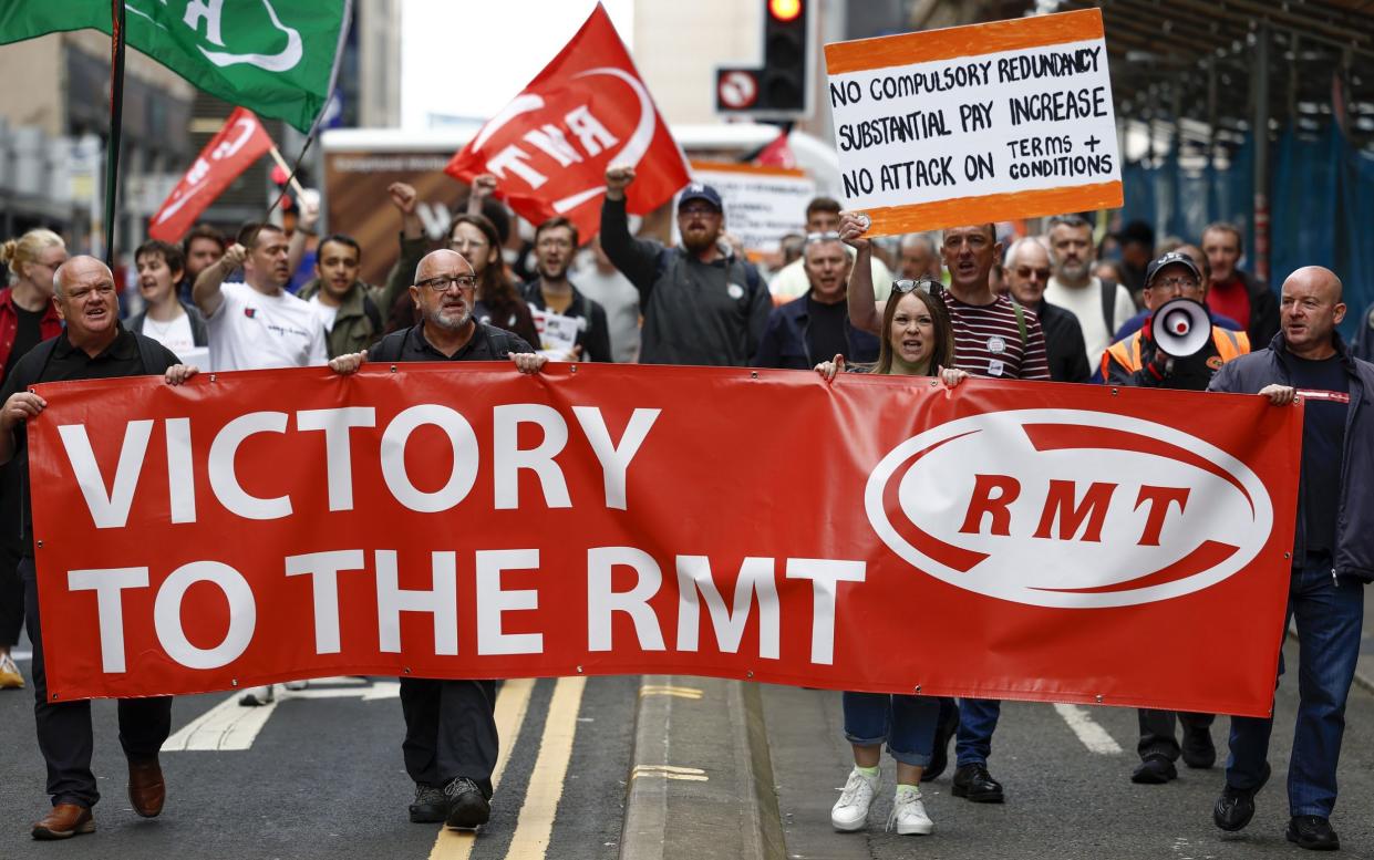 RMT supporters march from the offices of Network Rail