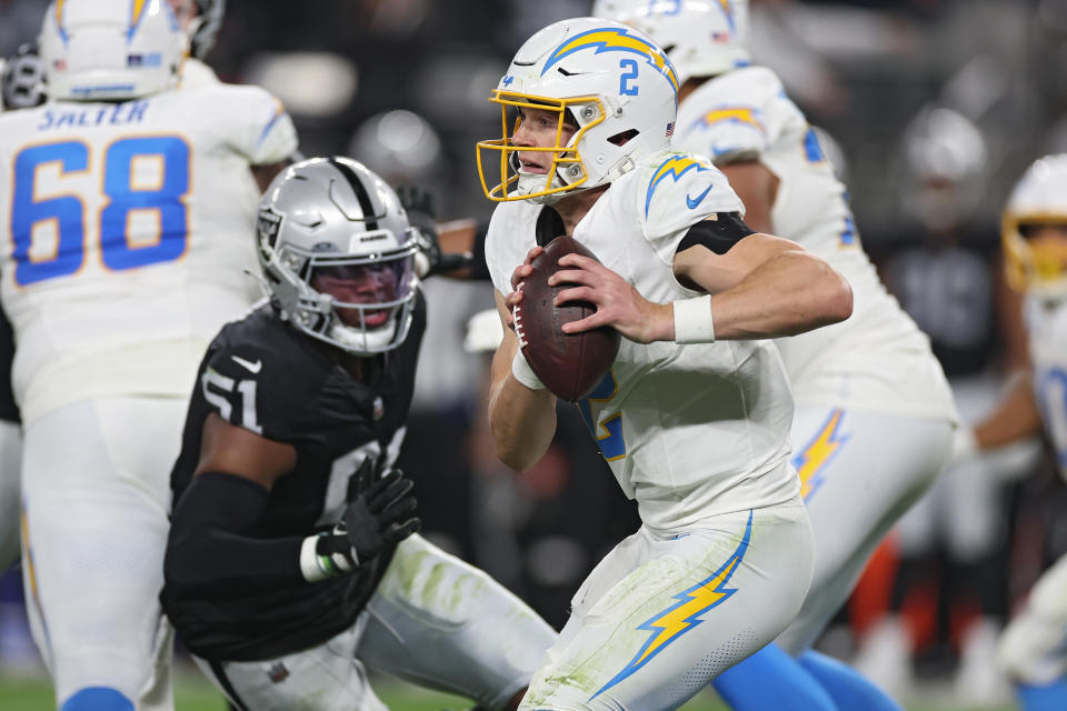 LAS VEGAS, NEVADA – DECEMBER 14: Quarterback <a class="link " href="https://sports.yahoo.com/nfl/players/31998" data-i13n="sec:content-canvas;subsec:anchor_text;elm:context_link" data-ylk="slk:Easton Stick;sec:content-canvas;subsec:anchor_text;elm:context_link;itc:0">Easton Stick</a> #2 of the Los Angeles Chargers looks to pass in front of defensive end Malcolm Koonce #51 of the <a class="link " href="https://sports.yahoo.com/nfl/teams/las-vegas/" data-i13n="sec:content-canvas;subsec:anchor_text;elm:context_link" data-ylk="slk:Las Vegas Raiders;sec:content-canvas;subsec:anchor_text;elm:context_link;itc:0">Las Vegas Raiders</a> during the second quarter at Allegiant Stadium on December 14, 2023 in Las Vegas, Nevada. (Photo by Sean M. Haffey/Getty Images)
