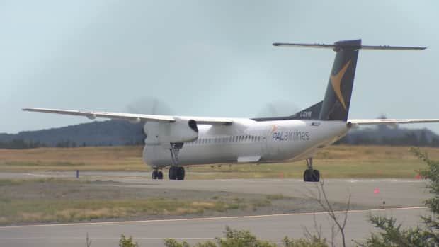 The first PAL Airlines flight from Ottawa and St. John's arrives on the runway Friday afternoon. The route is one of 12 new flights announced by the airline in June. (CBC - image credit)