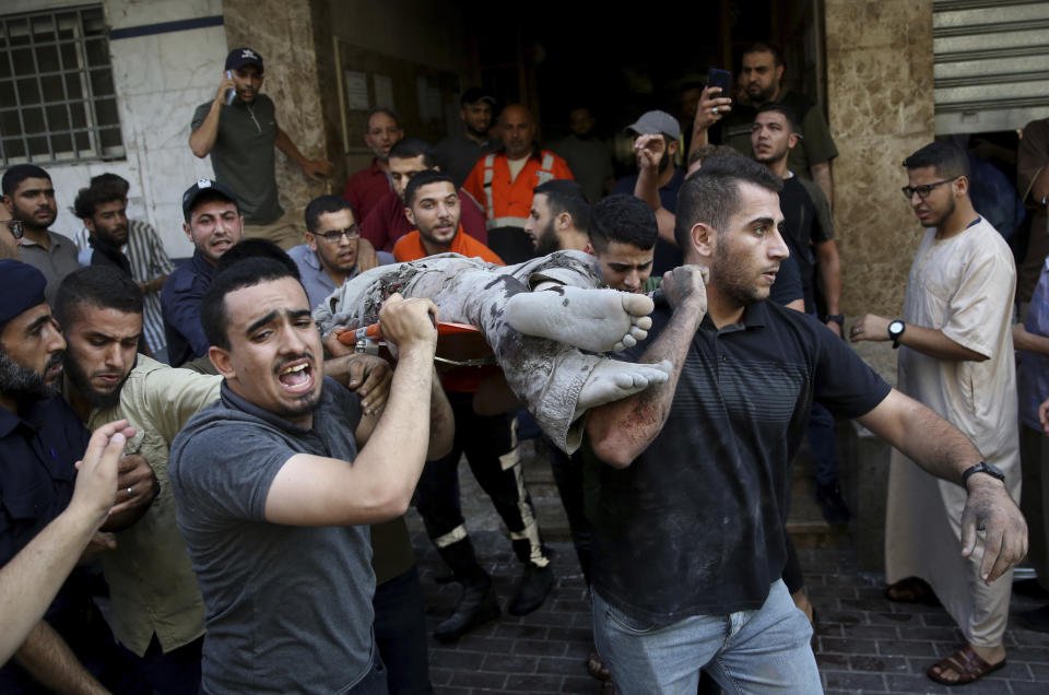 EDS NOTE: GRAPHIC CONTENT - Mourners carry the body of Taiseer al-Jabari, Islamic Jihad commander, who was killed during Israeli airstrikes on his apartment in Gaza City, Friday, Aug. 5, 2022. Palestinian officials say Israeli airstrikes on Gaza have killed several people, including a senior militant, and wounded 40 others. (AP Photo/Abdel Kareem Hana)