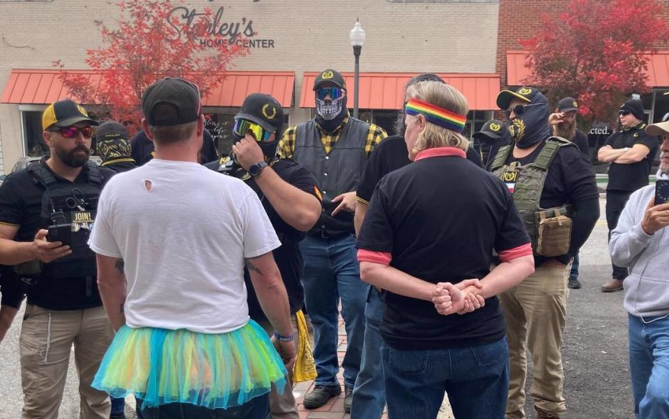 A drag brunch fundraiser Oct. 30, 2022 in Sanford, NC was disrupted by masked Proud Boys protesters. This photo, taken by event organizer Lindsey Knapp, shows two counter protesters talking with a group of Proud Boys. The brunch raised money for sex assault survivors and an LGBTQ resource center.