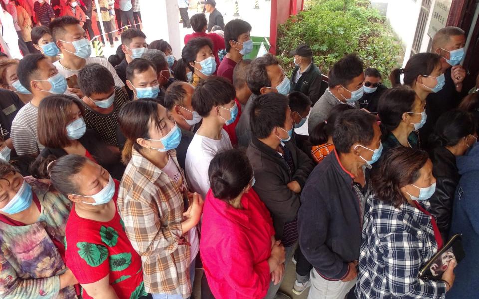 People queues to receive the vaccine in Linquan county, Fuyang city, in China's eastern Anhui province - AFP