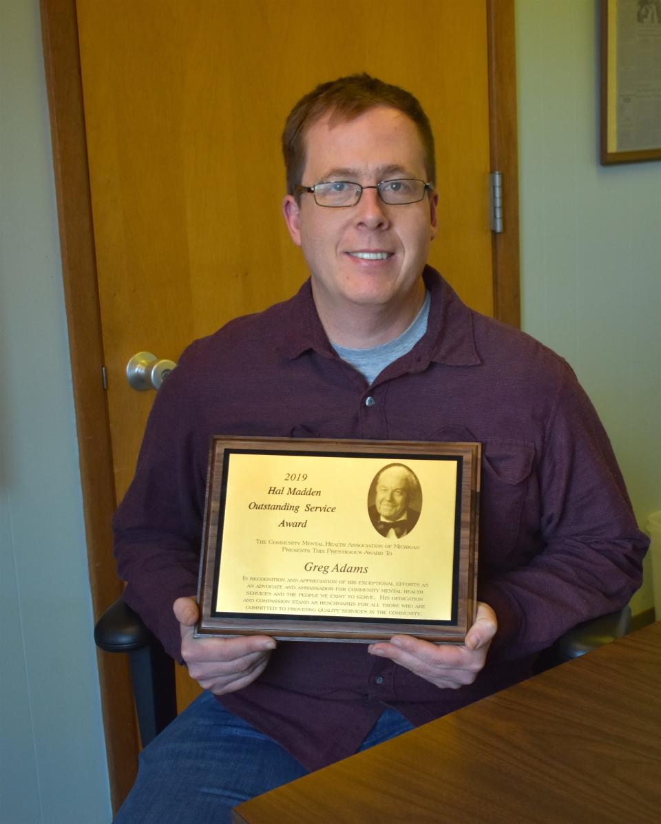 Greg Adams of Adrian shows off the Hal Madden Outstanding Public Service Award, which was presented to him Oct. 21, 2019, during the fall conference of the Community Mental Health Authority of Michigan in Traverse City. Adams, an advocate for mental health care, died Feb. 13, 2022, after being hit by a car.
