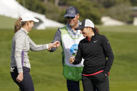 Heidi Ueberroth, left, is greeted by Mia Hamm, right, after putting on the third green of the Pebble Beach Golf Links during the third round of the AT&T Pebble Beach Pro-Am golf tournament in Pebble Beach, Calif., Saturday, Feb. 5, 2022. (AP Photo/Eric Risberg)