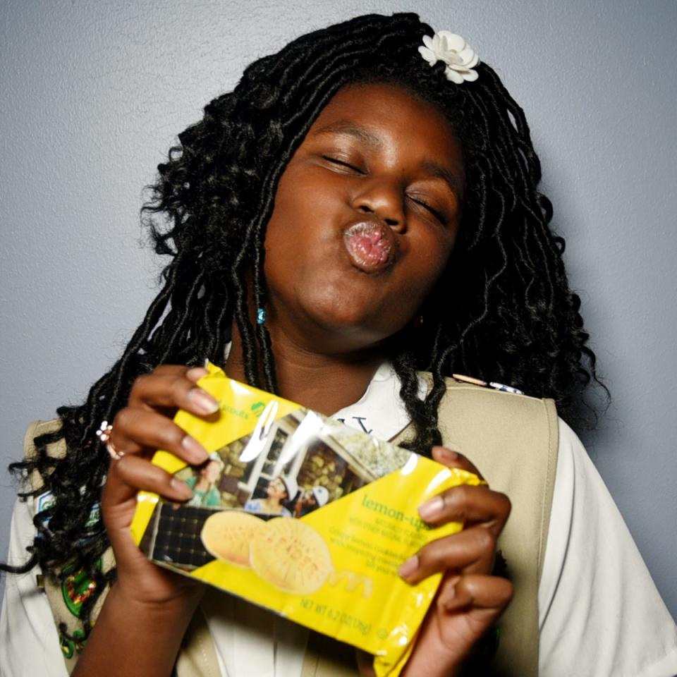 Girl Scout Carrington Hill with Lemon-ups cookies. "I've learned how handle my money and how to have conversations with people."