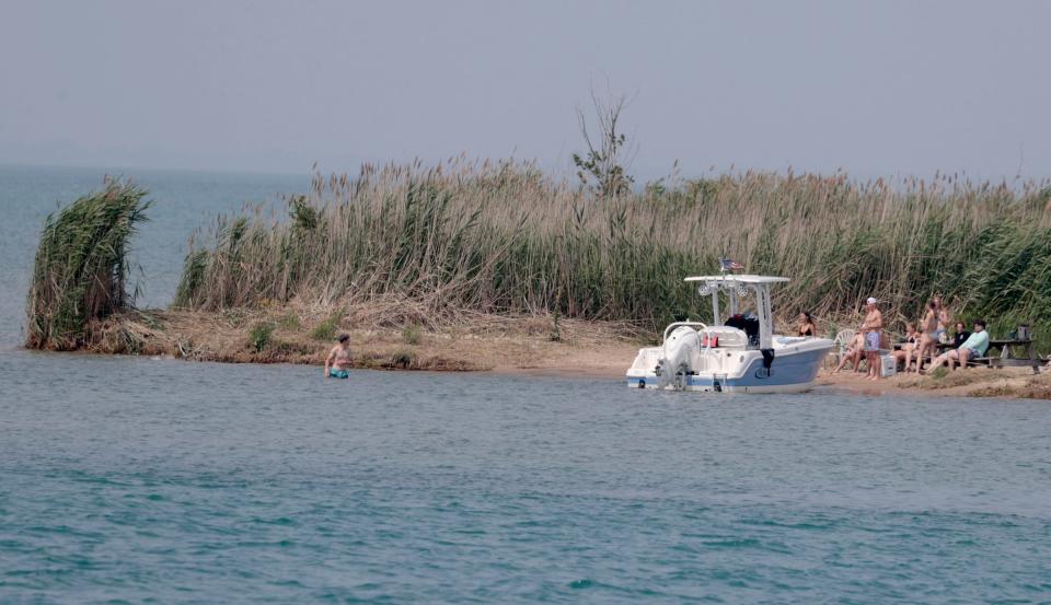 Boats enjoy the sandy beach on Gull Island off of Lake St. Clair on Wednesday, July 26, 2023.