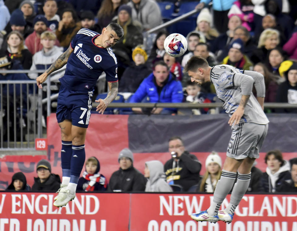 CF Montreal's Gabriete Corbo, right, heads the ball toward New England Revolution forward DeJuan Jones (24) in the first half of an MLS soccer match Saturday, April 8, 2023, in Foxborough, Mass. (AP Photo/Mark Stockwell)