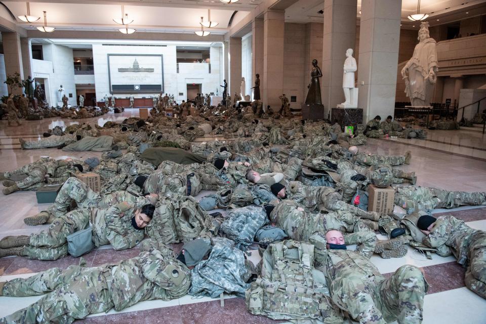 Members of the National Guard rest in the Capitol Visitors Center on Capitol Hill in Washington, DC, January 13, 2021, ahead of an expected House vote impeaching US President Donald Trump. - The Democrat-controlled US House of Representatives on Wednesday opened debate on a historic second impeachment of President Donald Trump over his supporters' attack of the Capitol that left five dead.Lawmakers in the lower chamber are expected to vote for impeachment around 3:00 pm (2000 GMT) -- marking the formal opening of proceedings against Trump. (Photo by SAUL LOEB / AFP) (Photo by SAUL LOEB/AFP via Getty Images)