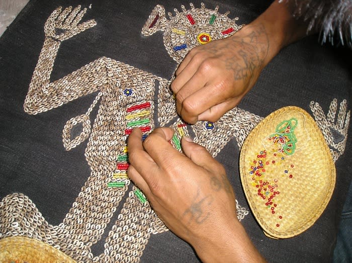 Beautification: Beads and shells are sewn onto a textile from Sumba. (