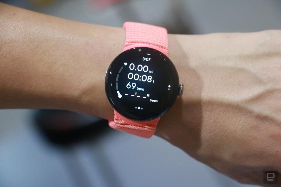The Pixel Watch 2 on a person's wrist, showing a workout metrics screen.