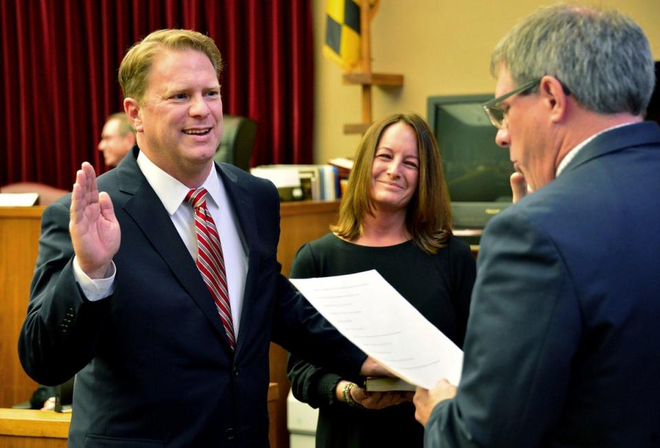 FILE - Washington County Circuit Court Clerk Kevin Tucker, right, swears in Andrew F. Wilkinson as a circuit court judge on Jan. 10, 2020, as Wilkinson's wife, Stephanie, watches. (Julie E. Greene/The Herald-Mail via AP)