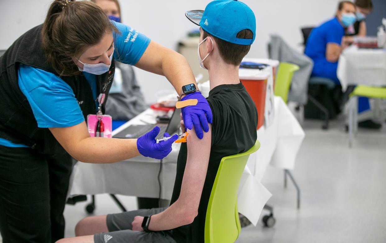 In this Thursday, May 13, 2021, file photo, nurse Erin Morgan administers the Pfizer COVID-19 vaccine to 14-year-old Zach Bilyj, of Wake Forest, N.C., during a vaccination clinic at the Wake County Human Services clinic on Departure Drive, in Raleigh, N.C.