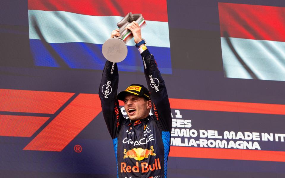 Max Verstappen celebrates with the winning trophy on the podium
