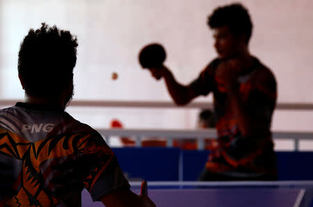 Papua New Guinea table tennis players Gasika Sepa and David Thomas play on a table during a practice session at a Beijing-funded facility in central Port Moresby in Papua New Guinea, November 19, 2018. REUTERS/David Gray