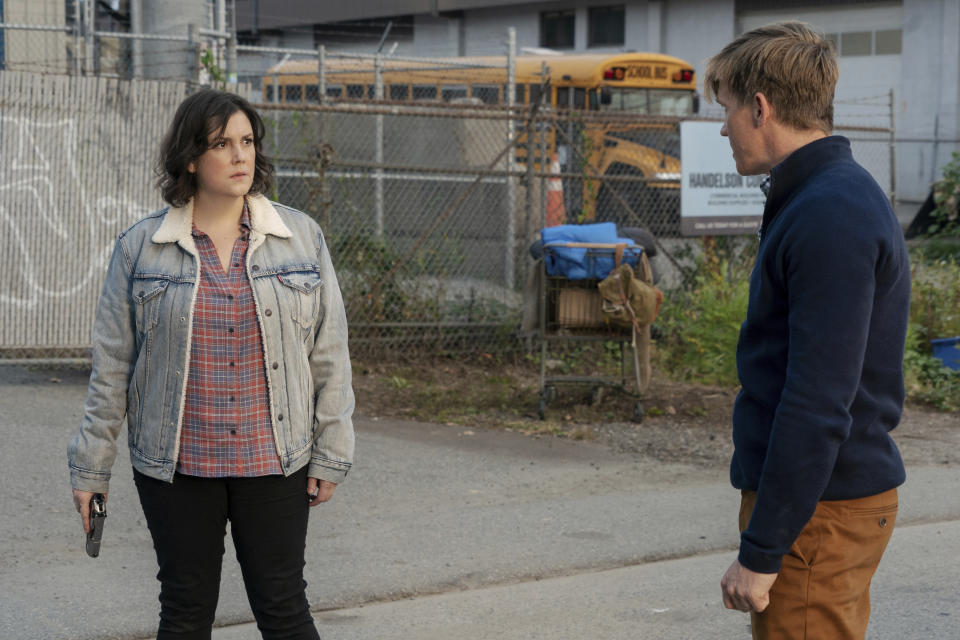 This image released by Showtime shows Melanie Lynskey, left, and Warren Kole in a scene from "Yellowjackets." (Colin Bentley/Showtime via AP)