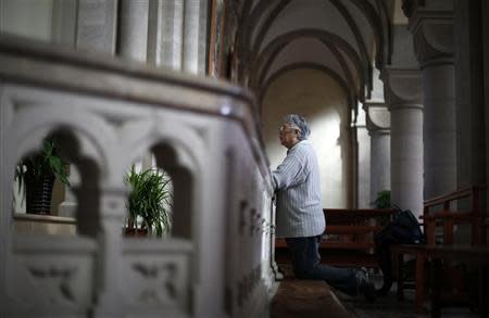 A woman prays at Sheshan Cathedral in the outskirts of Shanghai October 28, 2013. REUTERS/Aly Song