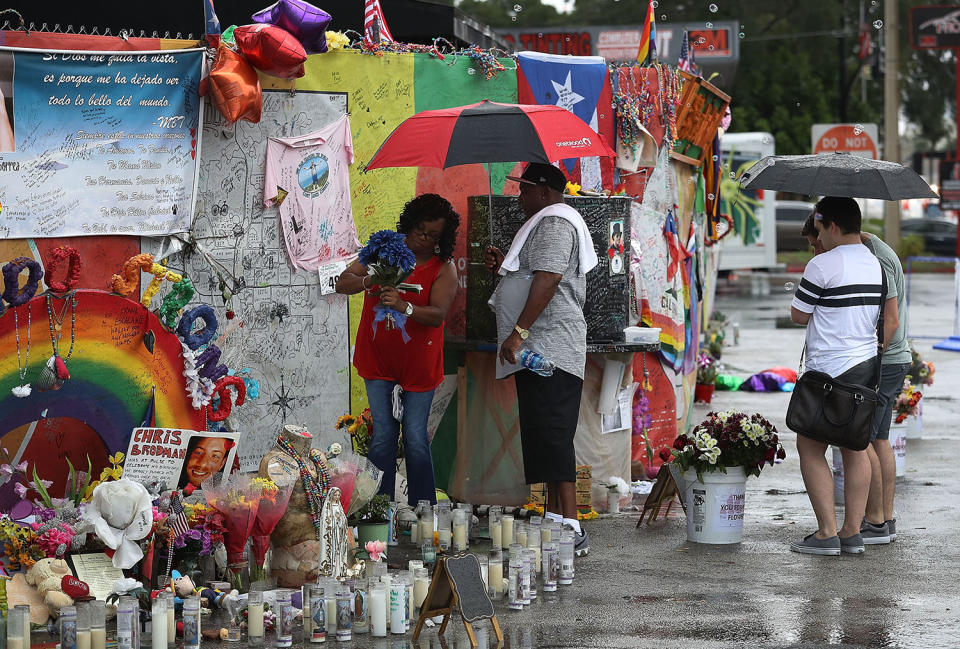 <p>People visit the memorial to the victims of the mass shooting setup around the Pulse gay nightclub one day before the one year anniversary of the shooting on June 11, 2017 in Orlando, Florida. (Joe Raedle/Getty Images) </p>