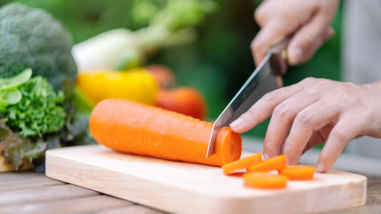 Person chopping a carrot