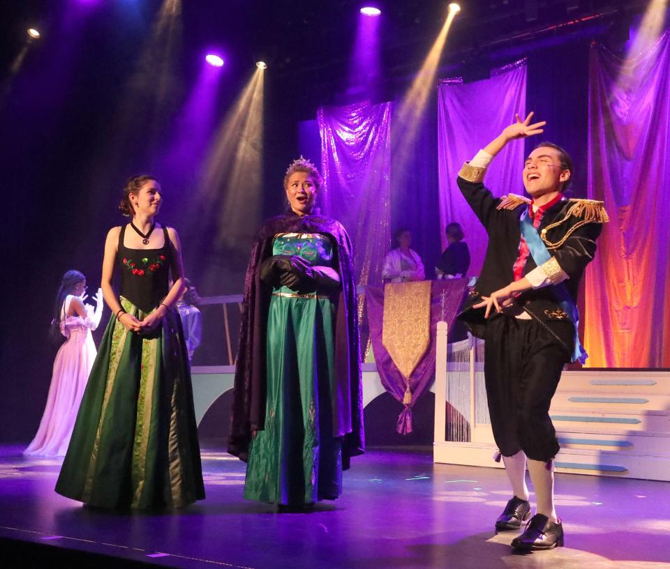 Lina Nasr, as Anna, and Libby McDonald, as Queen Elsa, react to Gavin Bryant, as Duke of Weselton, Tuesday, Feb. 6, 2024, during dress rehearsal of Spruce Creek High School's production of Disney's "Frozen Jr."