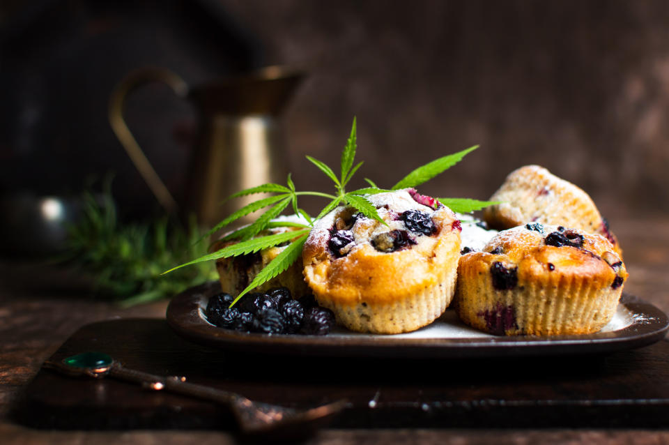 Marijuana leaf on top of blueberry muffins.