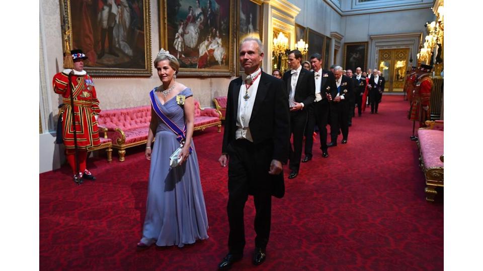 Duchess Sophie in a blue dress with a sash and a diamond tiara