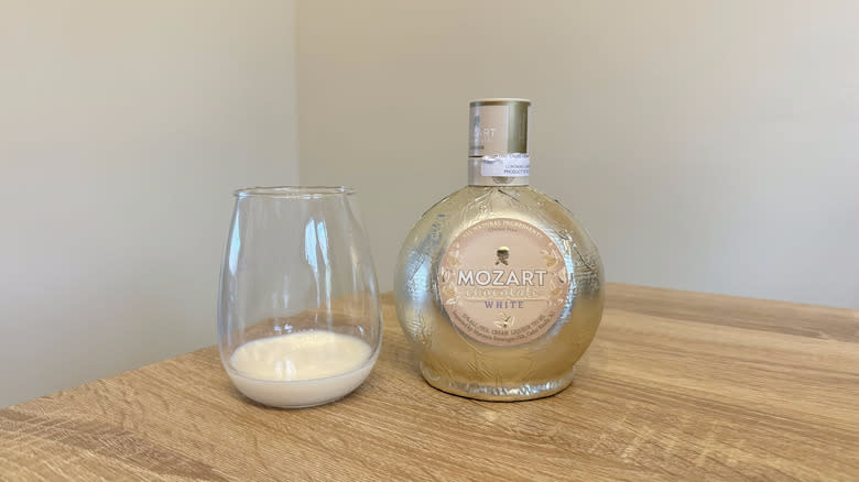 Glass and bottle of Mozart white chocolate liqueur
