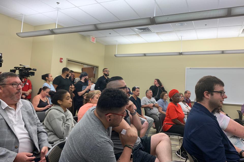 Residents crowd into a room at the Cranston Police Department on Monday after a 24-unit apartment complex was condemned following flash floods a day earlier.
