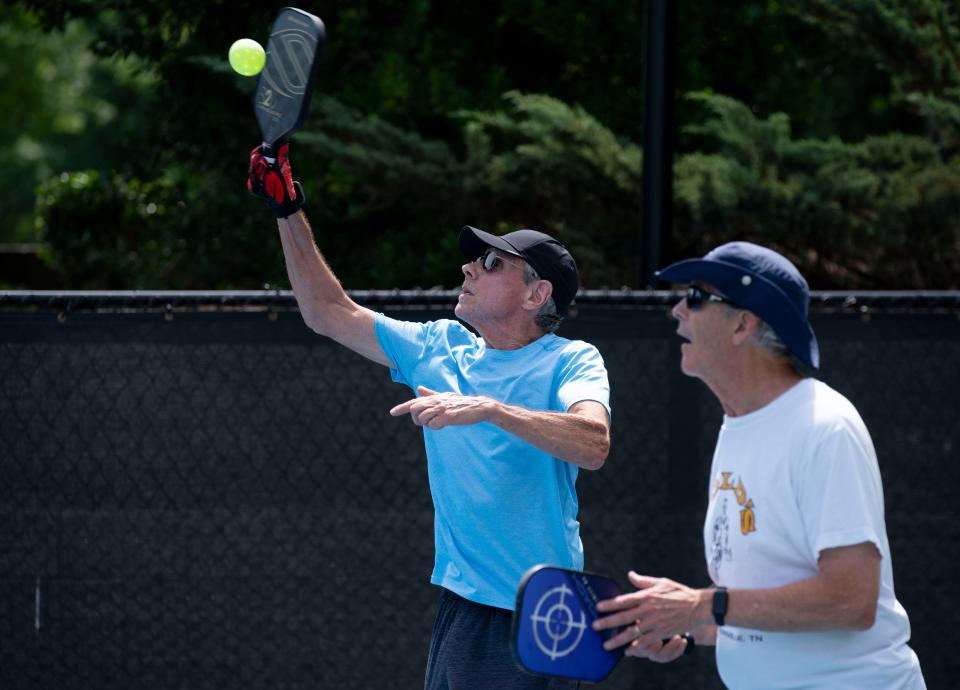 David Klintworth, left, hits an overhead shot with pickleball partner David Knapp at Del Webb Sports Complex in Mt. Juliet, Tenn., Wednesday, June 12, 2024. Del Webb at Lake Providence will hold a pickleball party to benefit the Alzheimer Association’s Tennessee chapter on June 20.