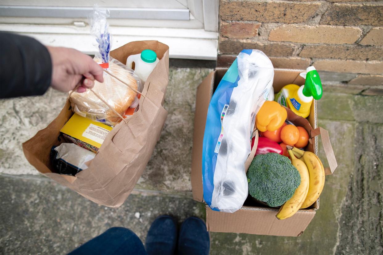 Groceries being delivered in paper bag and cardboard box