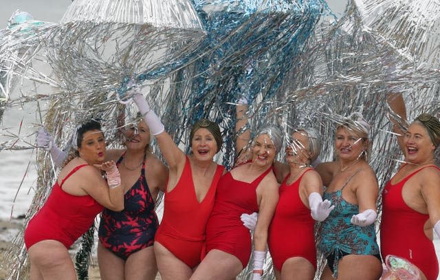 Members of the Bray Beach Bathers arrive to take part in the annual New Year’s day charity swim on Bray seafront in County Wicklow