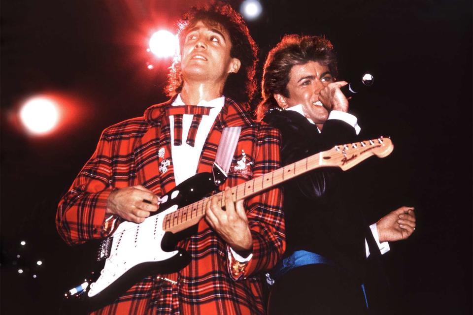 <p>Phil Dent/Redferns/Getty</p> Andrew Ridgeley and George Michael of Wham! perform in London in 1984