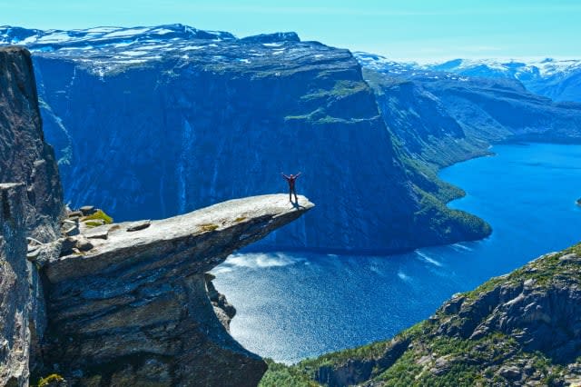 Trolltunga summer view (Norway) and man on rocks edge.