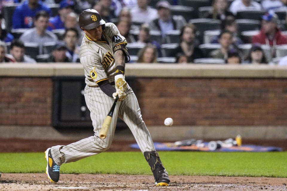 San Diego Padres' Manny Machado hits a two-run double during the fifth inning of the team's baseball game against the New York Mets on Tuesday, April 11, 2023, in New York. (AP Photo/Frank Franklin II)