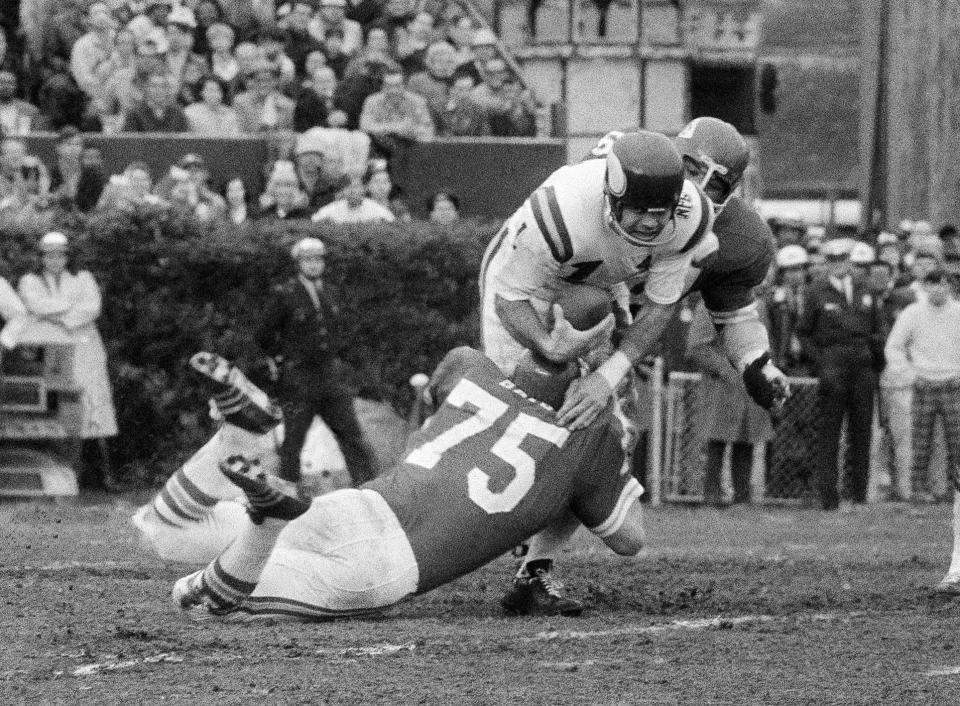 Minnesota Viking quarterback Joe Kapp is tackled by Jerry Mays (75) of the Kansas City Chiefs as another Chiefs defender moves in from the rear during the first half of Super Bowl IV at Tulane Stadium, Jan. 11, 1970, in New Orleans. (AP Photo/JS, File)