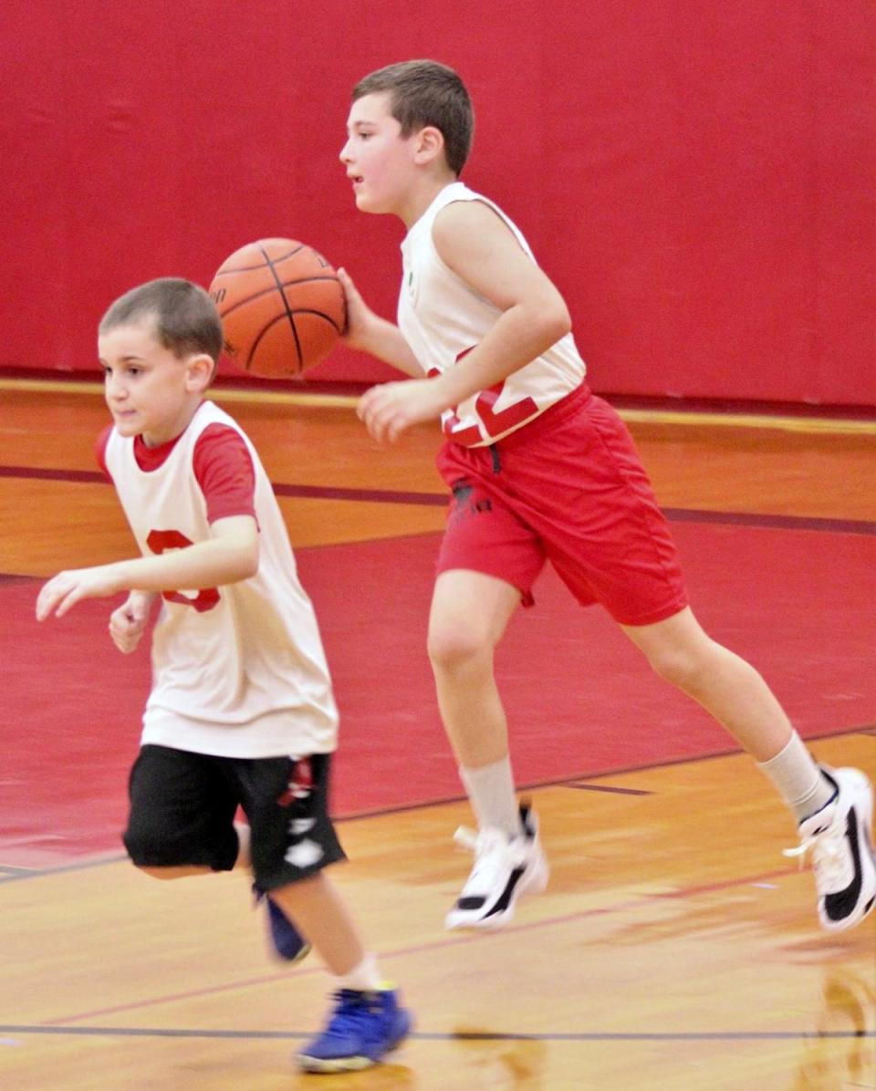 Westin Gillow (22) of the Cavaliers brings the ball upcourt during Honesdale Biddy Basketball Association action at Lakeside Elementary. Also pictured is Logan Davis (3).