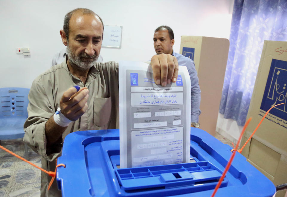 An Iraqi patient casts his vote at a polling center inside al-Kindi hospital in Baghdad, Iraq, Monday, April 28, 2014. Amid tight security, some one million Iraqi army and police personnel have started voting for the nation's new parliament. (AP Photo/ Karim Kadim)