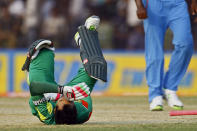 Bangladesh's Mushfiqur Rahim reacts in pain after he was hit by a ball during the Asia Cup one-day international cricket tournament against India in Fatullah, near Dhaka, Bangladesh, Wednesday, Feb. 26, 2014. (AP Photo/A.M. Ahad)